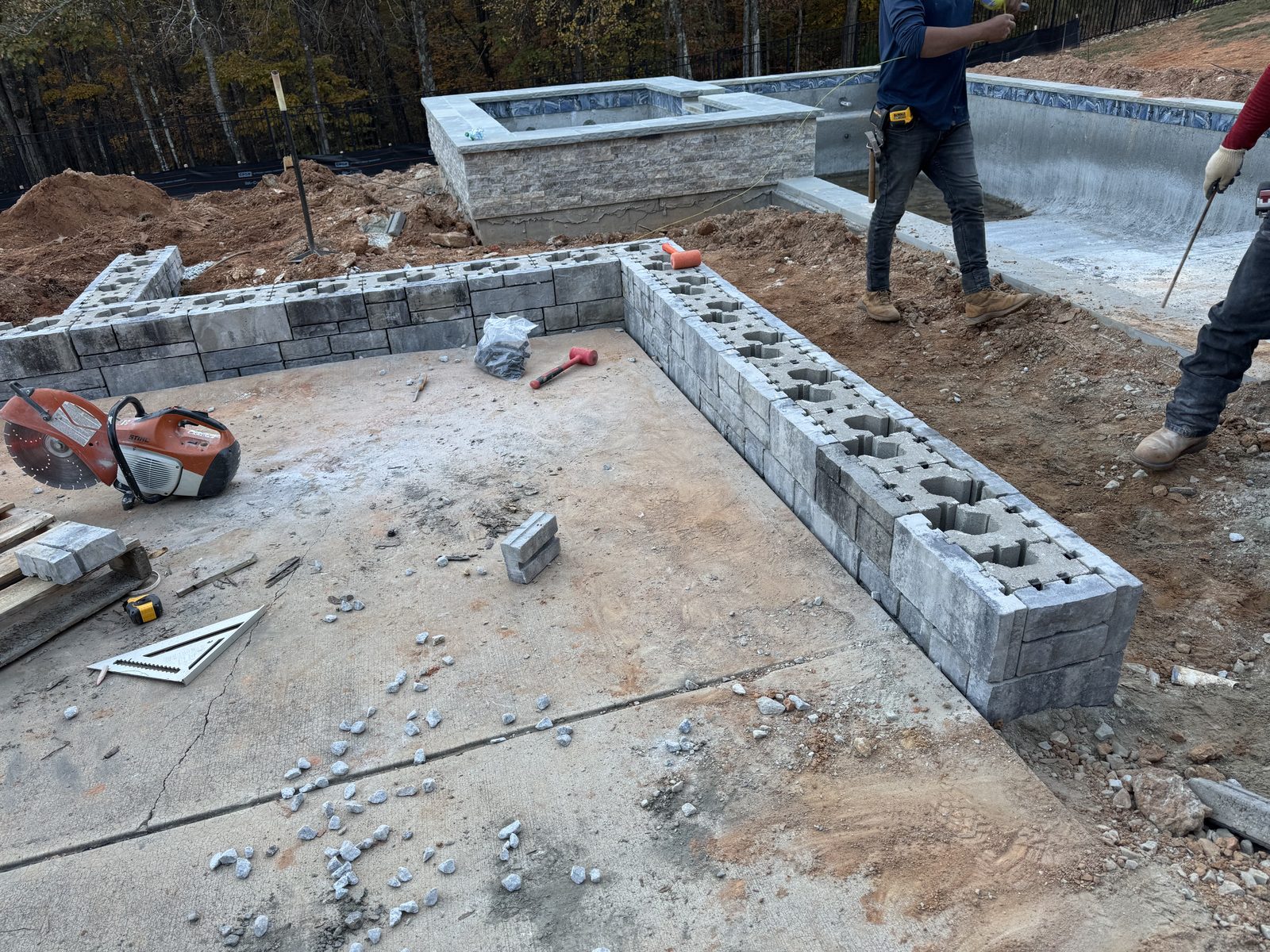Block retaining wall under construction