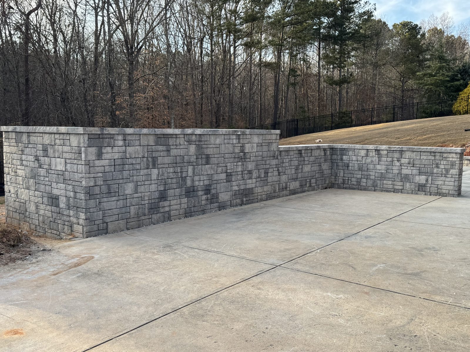 Finished retaining wall enclosing patio