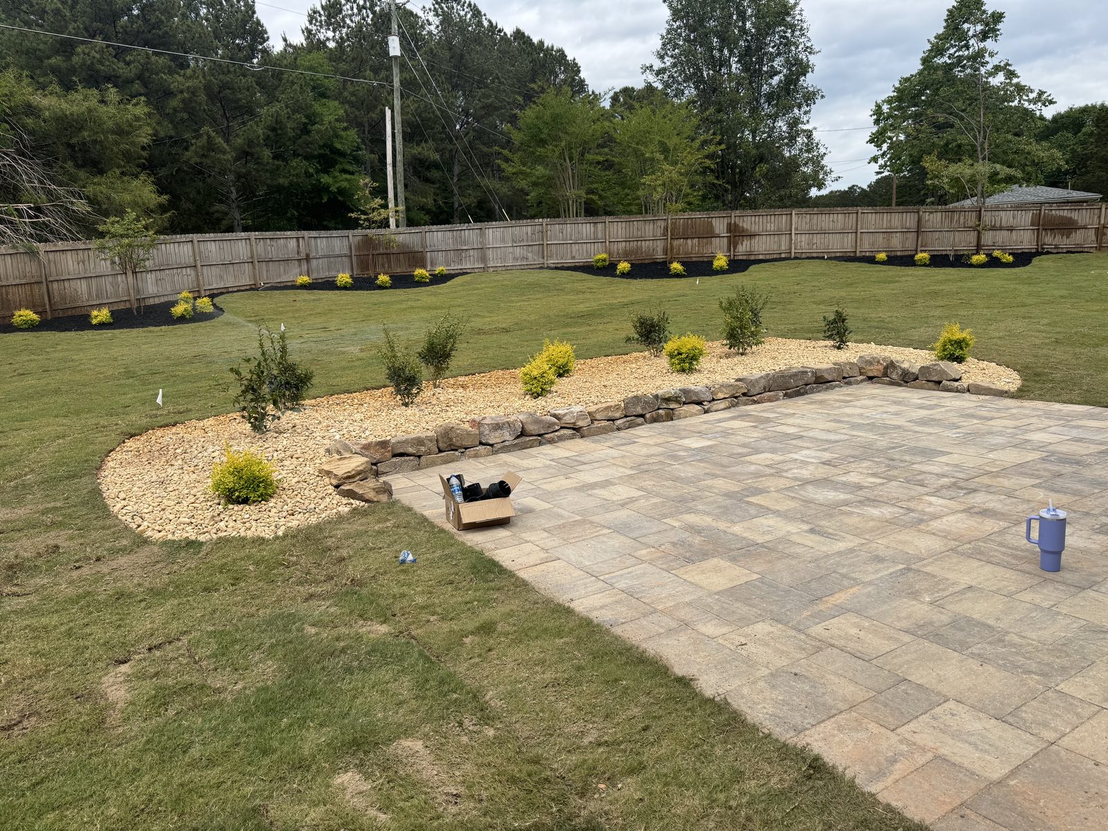 After patio and lawn transformation with fresh grass around the patio