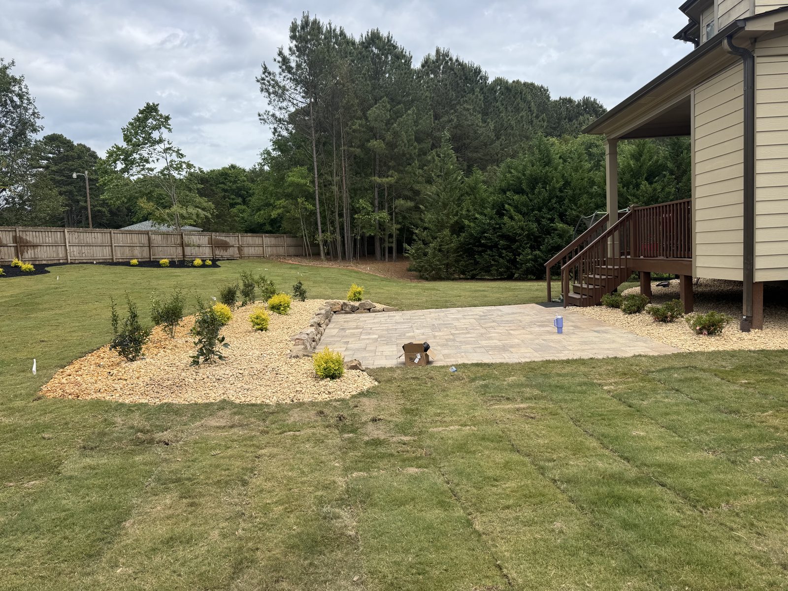 Fresh sod and patio extension beside home